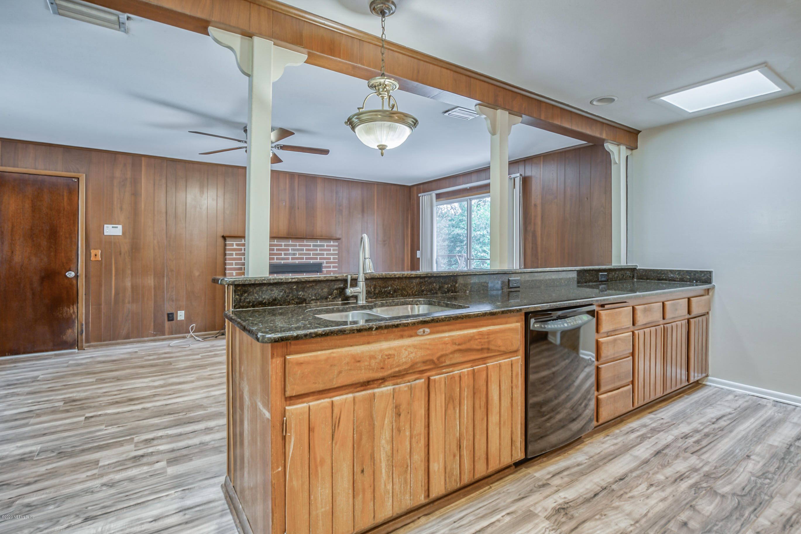 1305 Timber Lane Jacksonville, FL 32211 - Photo 14 of 58 a kitchen with granite countertop a sink cabinets and wooden floor