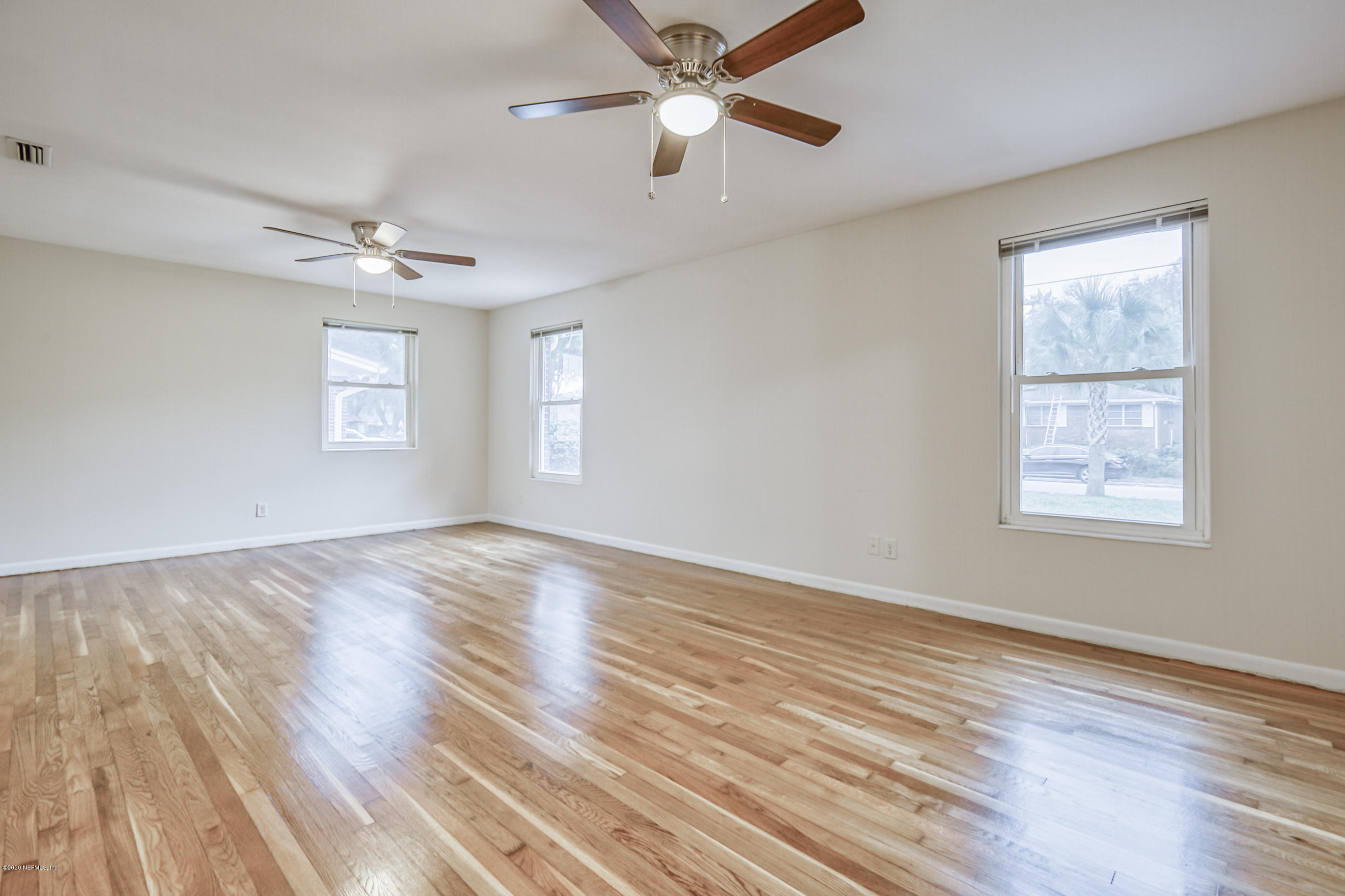 1305 Timber Lane Jacksonville, FL 32211 - Photo 18 of 58 a view of empty room with wooden floor and fan