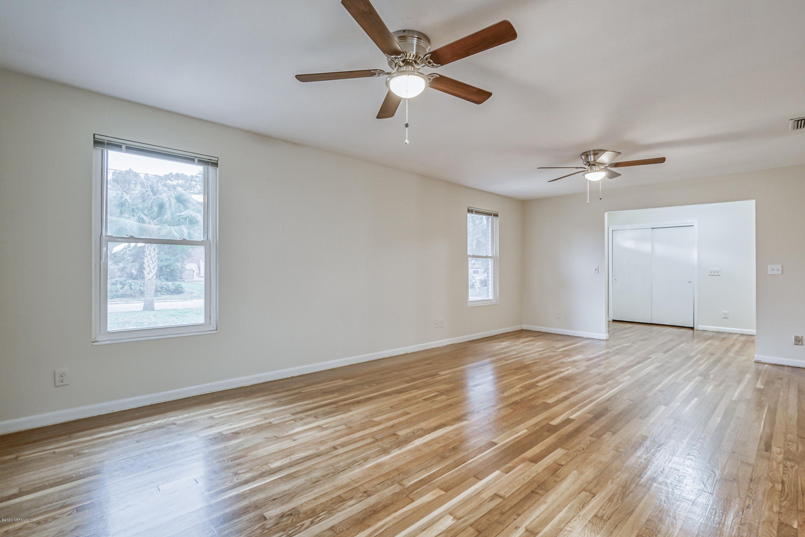 1305 Timber Lane Jacksonville, FL 32211 - Photo 21 of 58 wooden floor in an empty room with a window