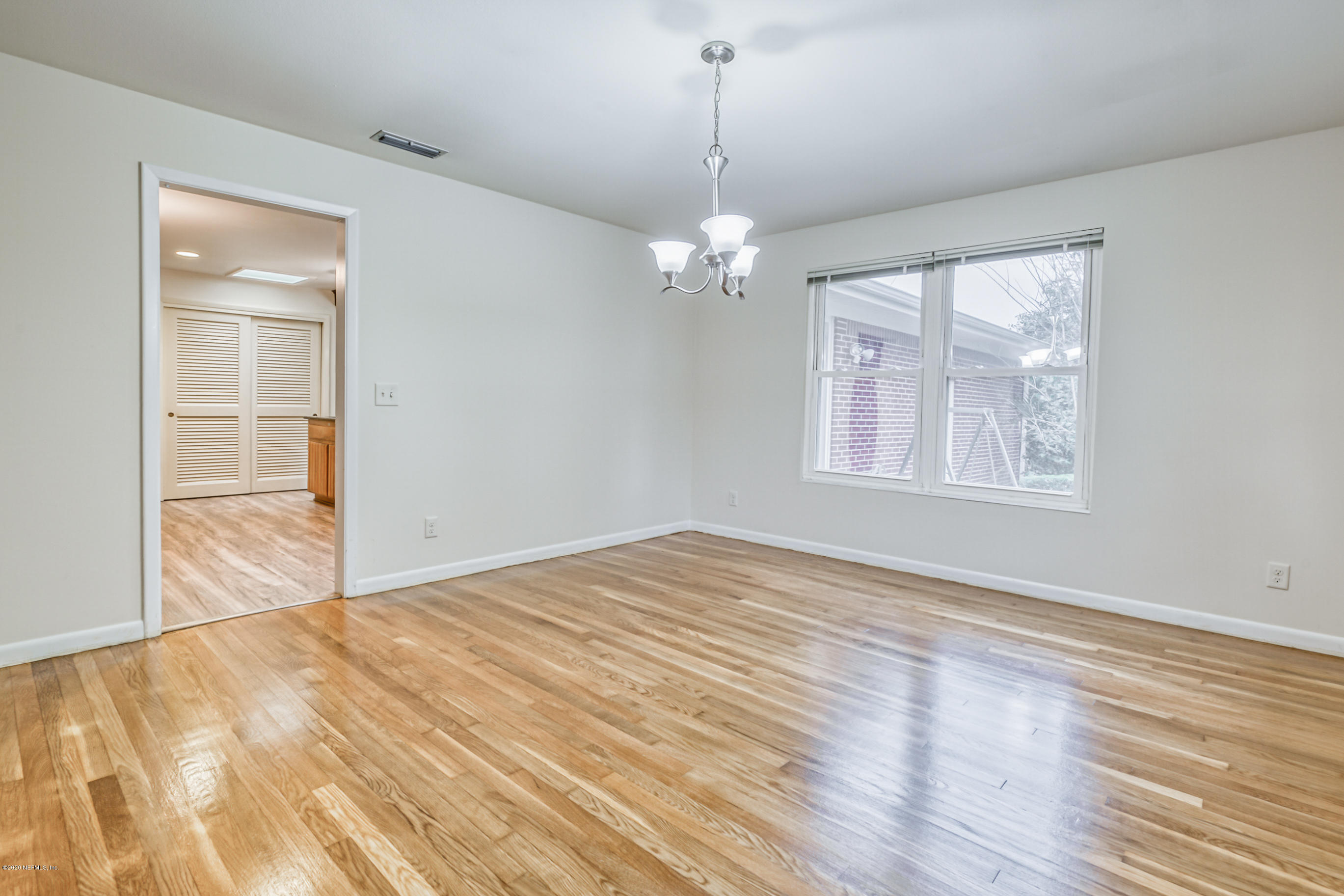 1305 Timber Lane Jacksonville, FL 32211 - Photo 23 of 58 a view of an empty room with wooden floor and a window