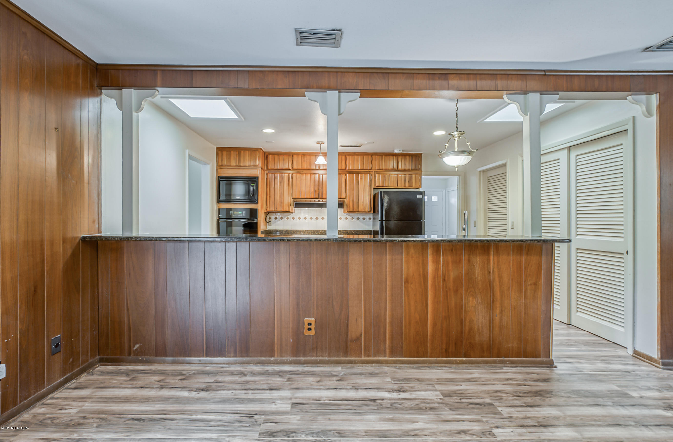 1305 Timber Lane Jacksonville, FL 32211 - Photo 27 of 58 a view of a hallway with stainless steel appliances granite countertop wooden cabinets and a large window