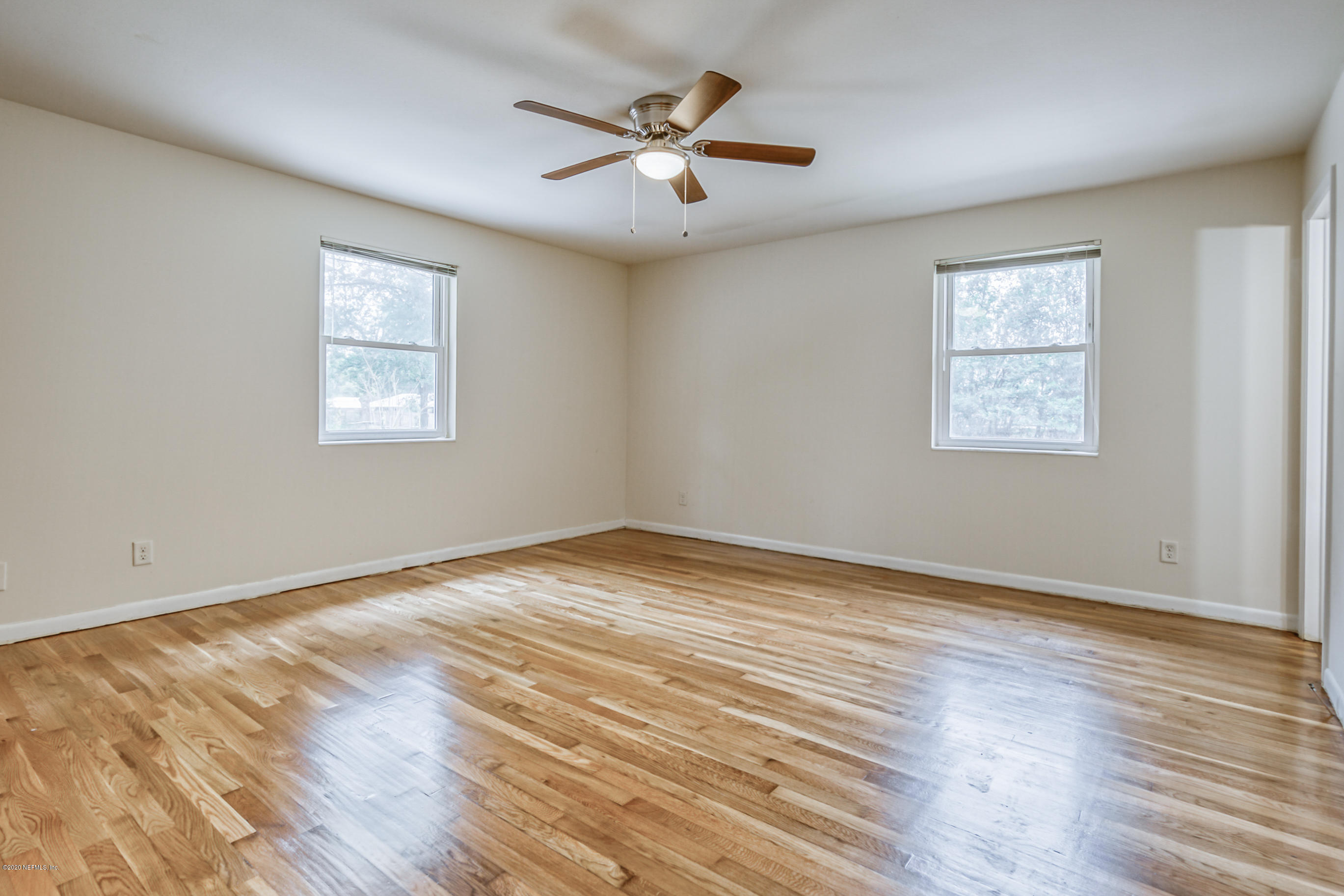 1305 Timber Lane Jacksonville, FL 32211 - Photo 32 of 58 a view of an empty room with wooden floor and a window