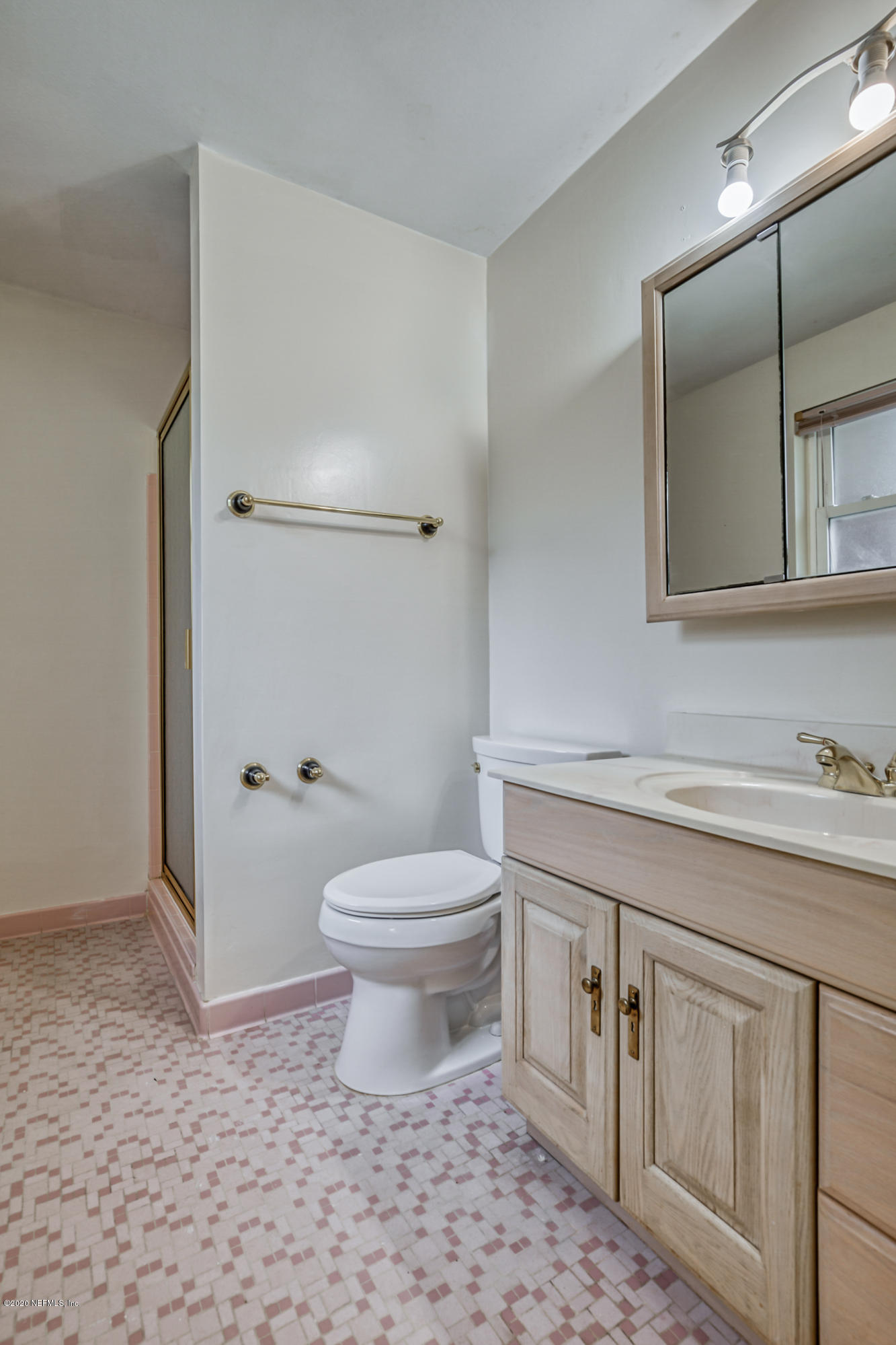 1305 Timber Lane Jacksonville, FL 32211 - Photo 35 of 58 a bathroom with a toilet a sink a vanity and mirror
