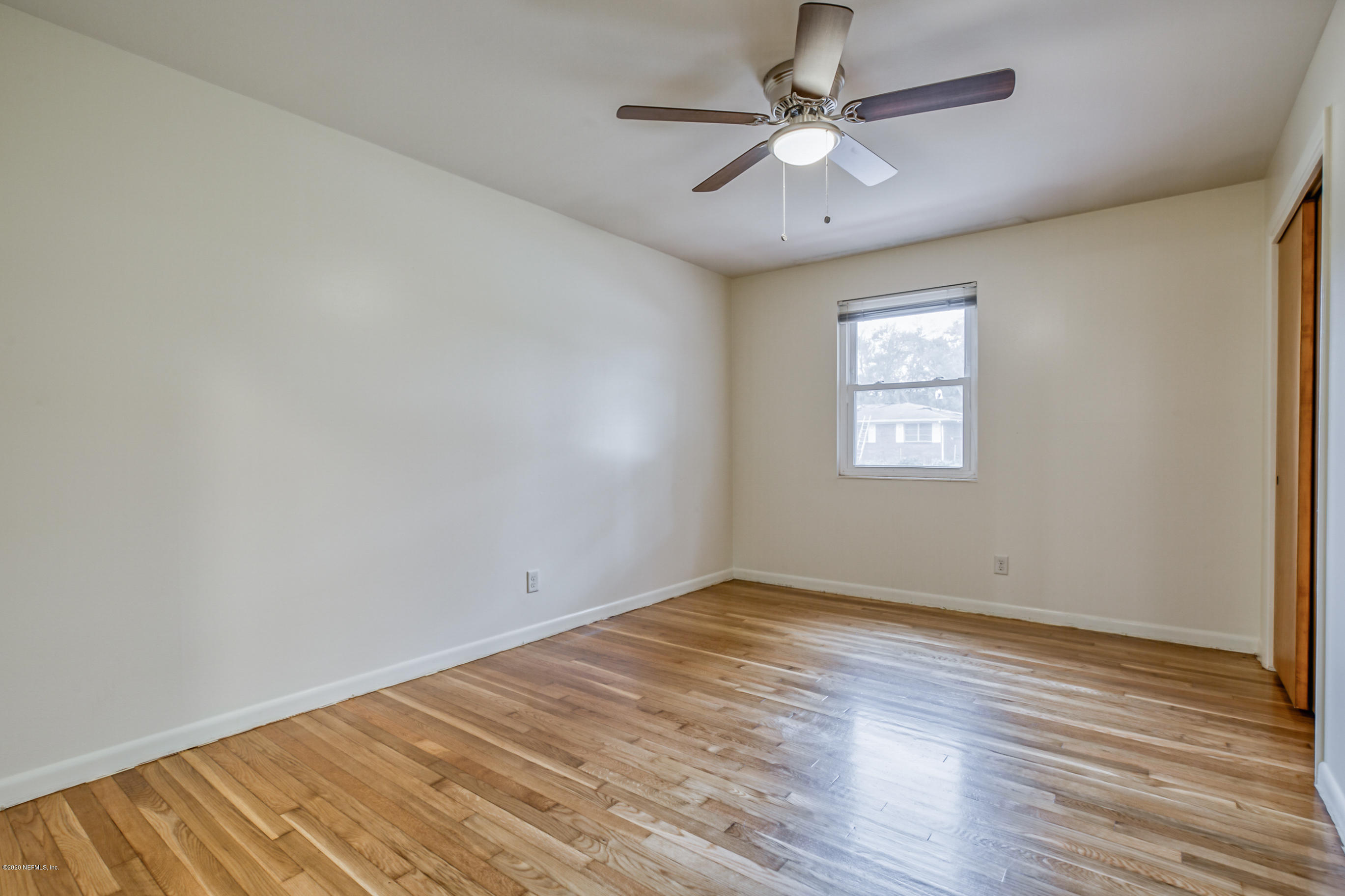 1305 Timber Lane Jacksonville, FL 32211 - Photo 36 of 58 an empty room with wooden floor and windows