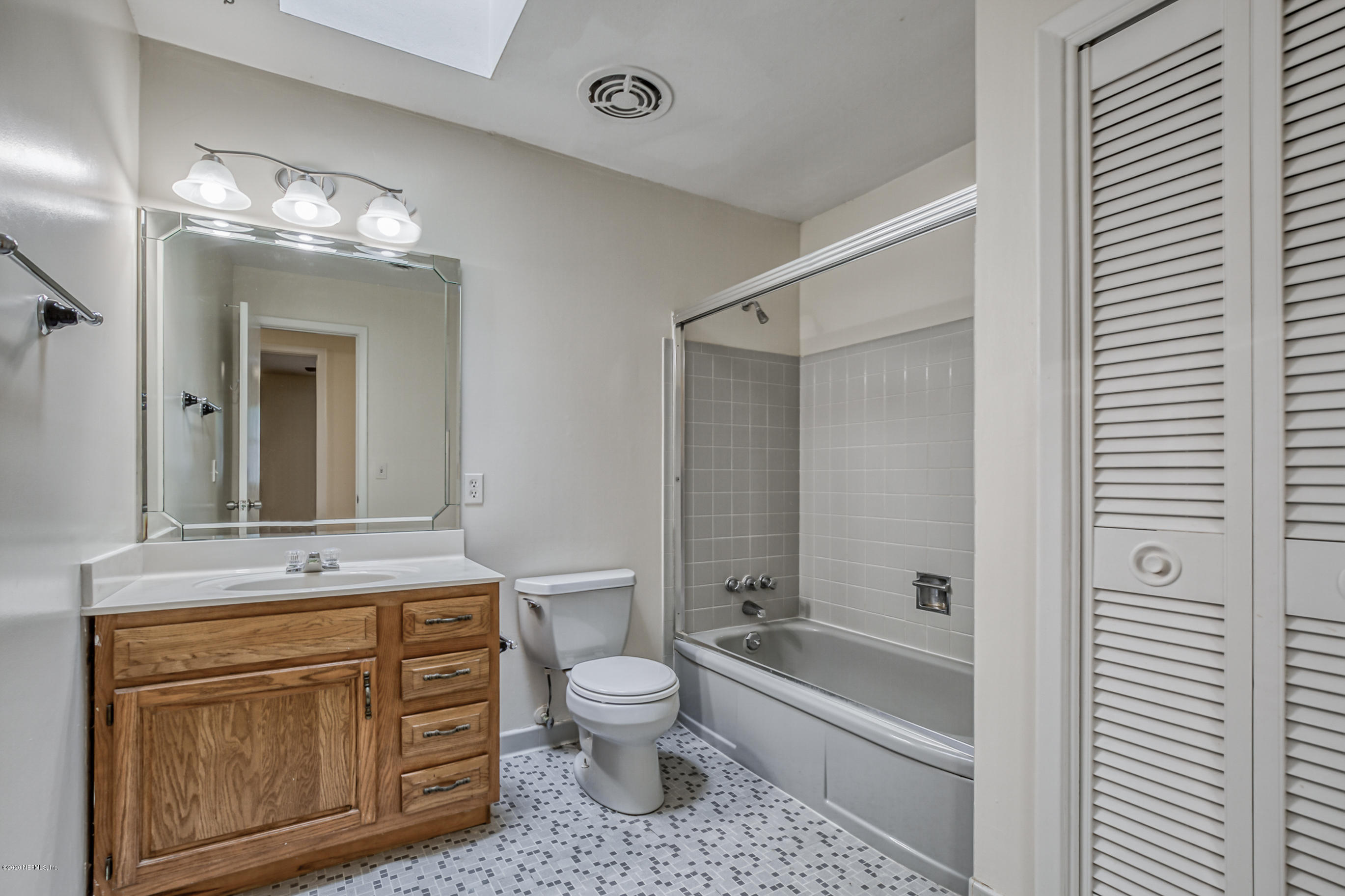 1305 Timber Lane Jacksonville, FL 32211 - Photo 38 of 58 a bathroom with a sink a toilet a mirror and bathtub