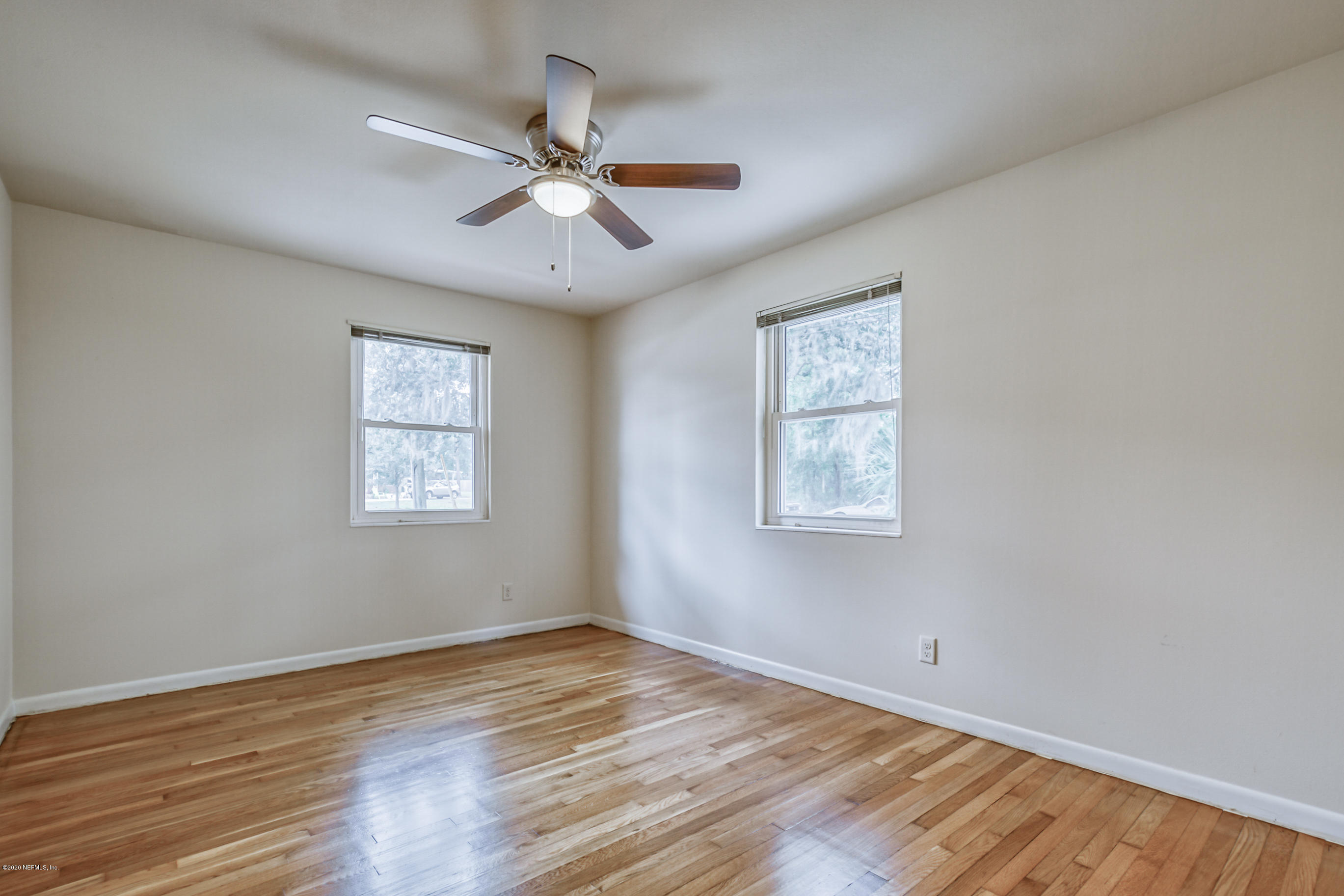 1305 Timber Lane Jacksonville, FL 32211 - Photo 40 of 58 a view of an empty room with wooden floor and a window