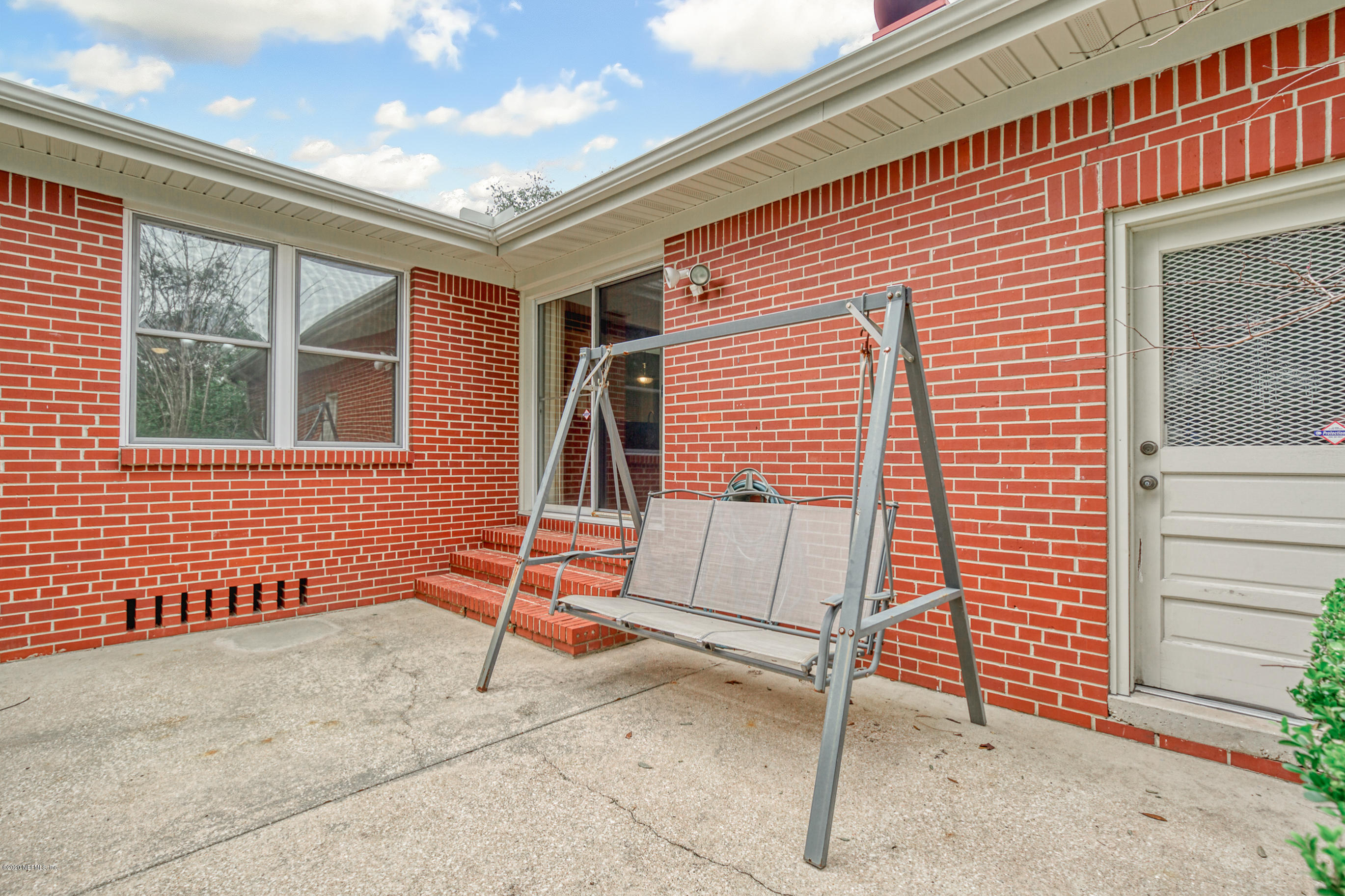 1305 Timber Lane Jacksonville, FL 32211 - Photo 52 of 58 a backyard of a house with table and chairs