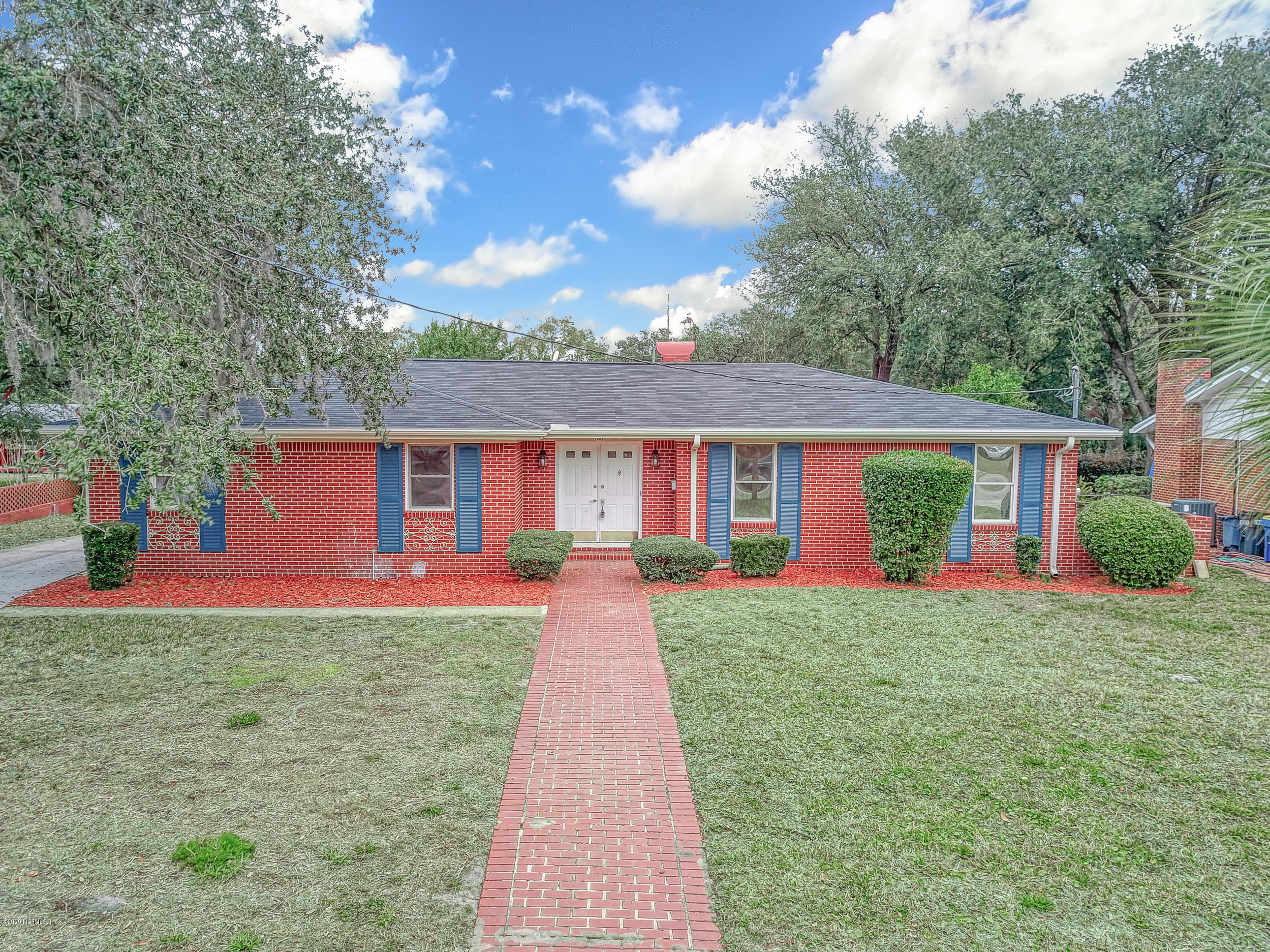 1305 Timber Lane Jacksonville, FL 32211 - Photo 54 of 58 a front view of a house with a yard and garage