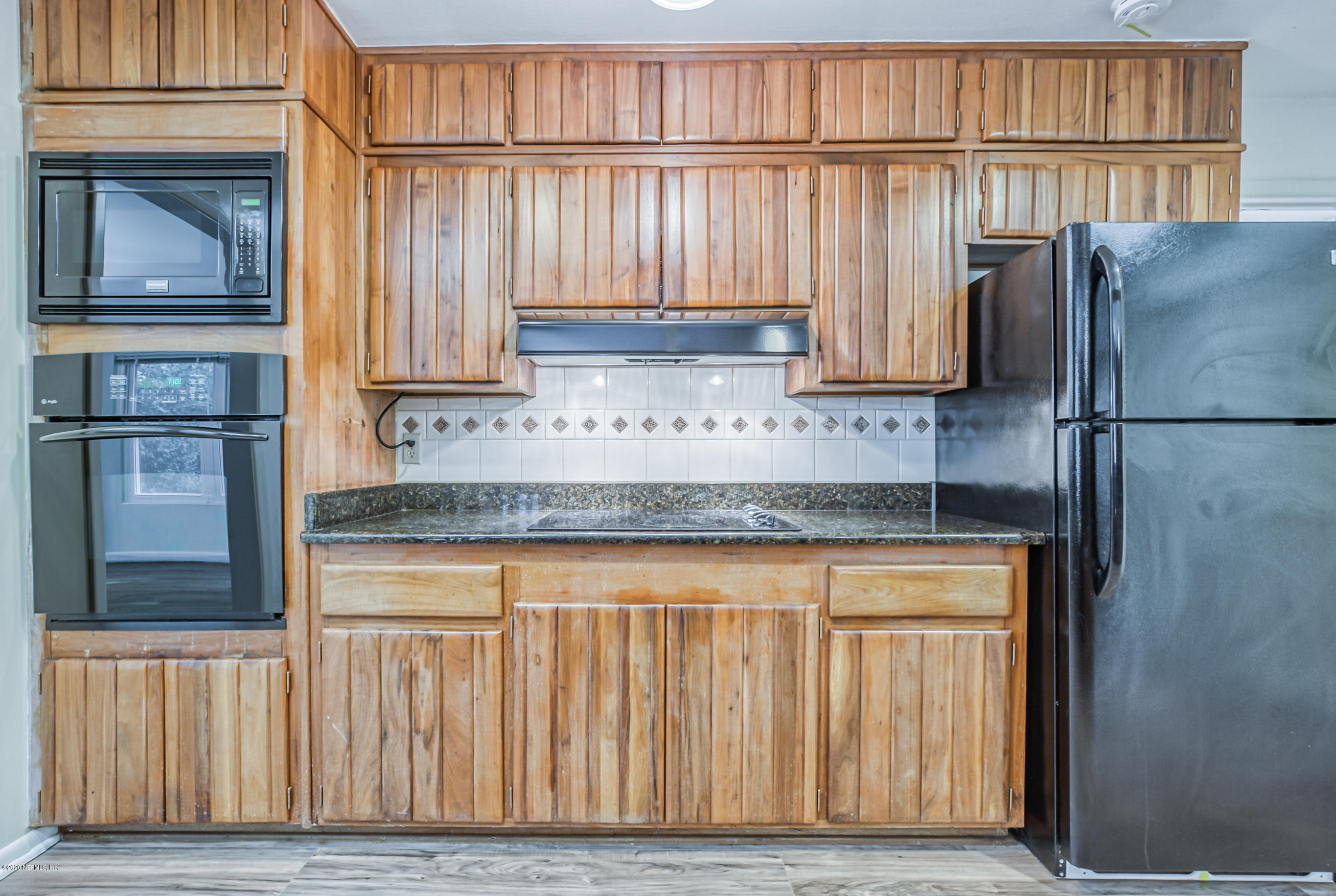 1305 Timber Lane Jacksonville, FL 32211 - Photo 10 of 58 a kitchen with stainless steel appliances granite countertop a refrigerator a stove and a sink with wooden cabinets