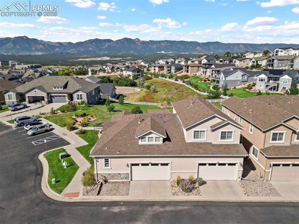 an aerial view of residential houses with outdoor space and parking