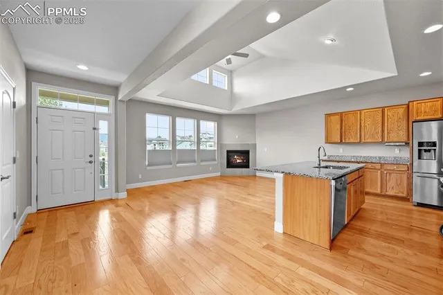 a large kitchen with stainless steel appliances granite countertop a stove and a sink