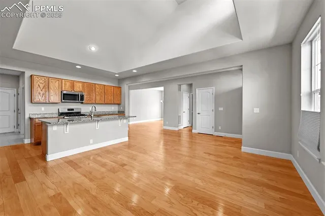 a view of a kitchen with a sink and cabinets