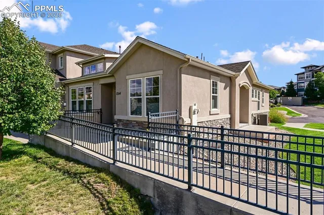 a view of a house with a wooden fence