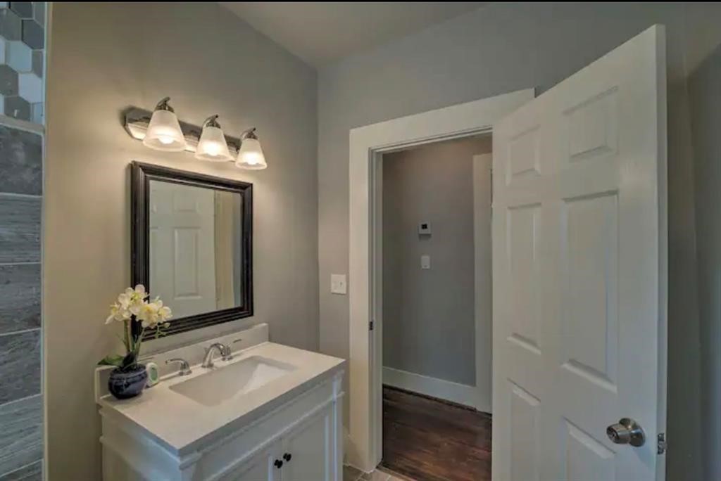 5224 Leeland Street Houston, TX 77023 - Photo 15 of 16 a bathroom with a sink vanity and a mirror