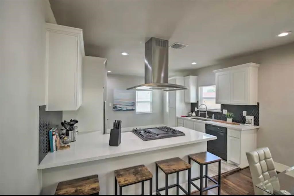 5224 Leeland Street Houston, TX 77023 - Photo 9 of 16 a kitchen with a table chairs stove and cabinets
