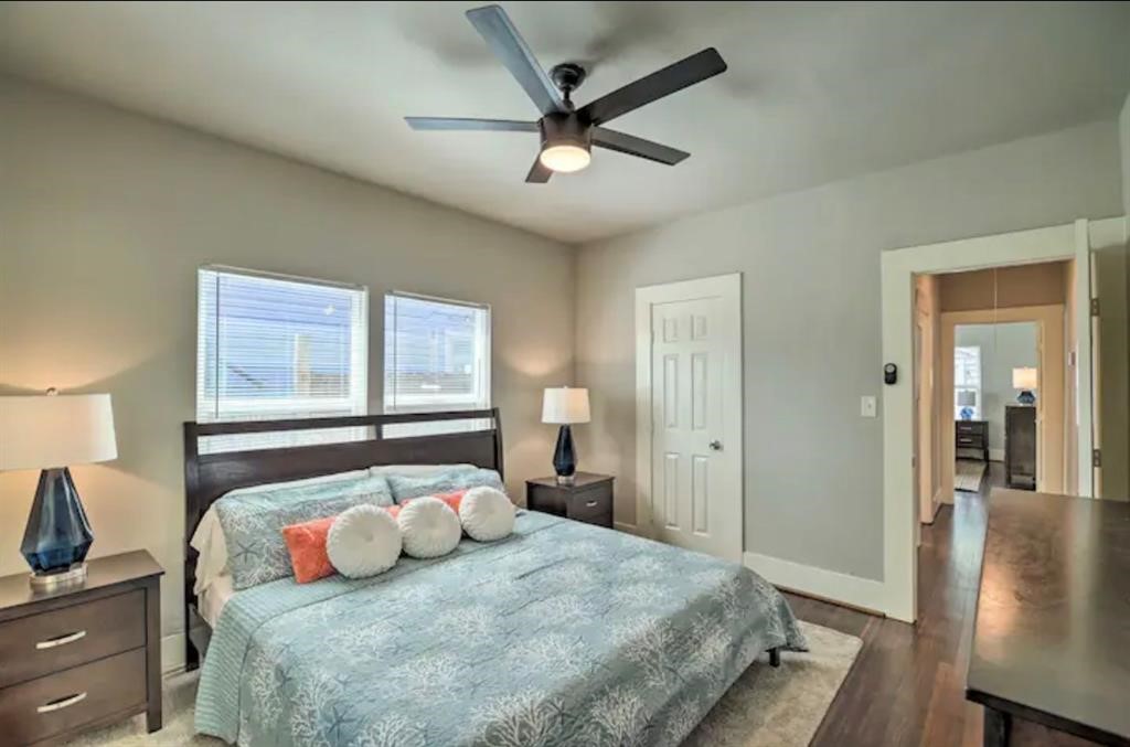 5224 Leeland Street Houston, TX 77023 - Photo 10 of 16 a bedroom with a large bed a chandelier and a window