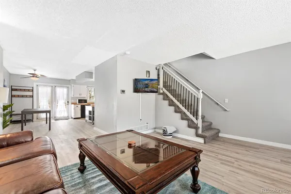 a living room with furniture and wooden floor