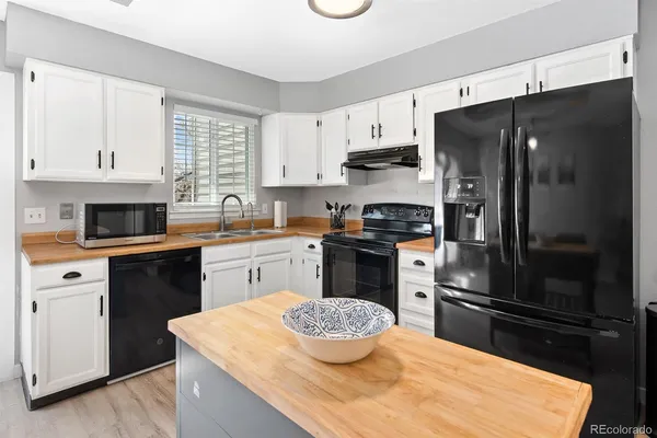 a kitchen with a sink a stove and refrigerator