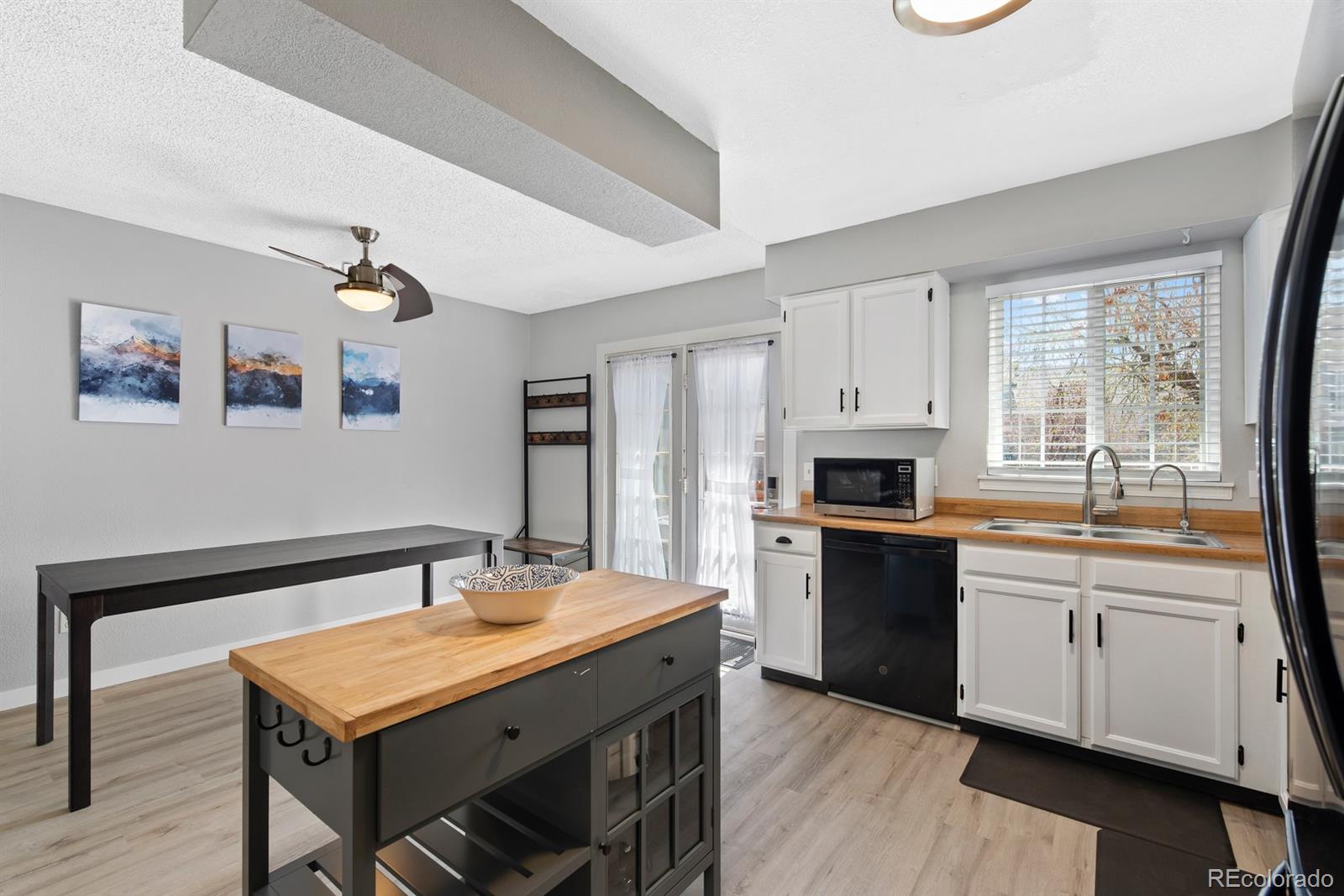 19927 Briarwood Court Parker, CO 80138 - Photo 13 of 29 a kitchen with stainless steel appliances granite countertop a stove a sink dishwasher and a refrigerator with wooden floor