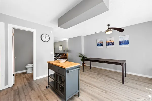 a view of a room with wooden floor and furniture