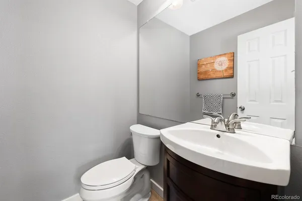 a bathroom with a sink a toilet and mirror