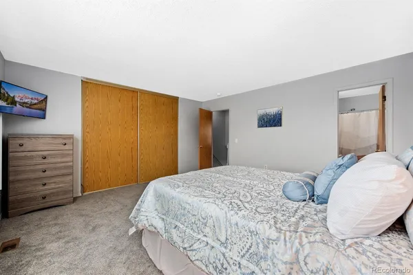 a bedroom with a bed and a cabinets