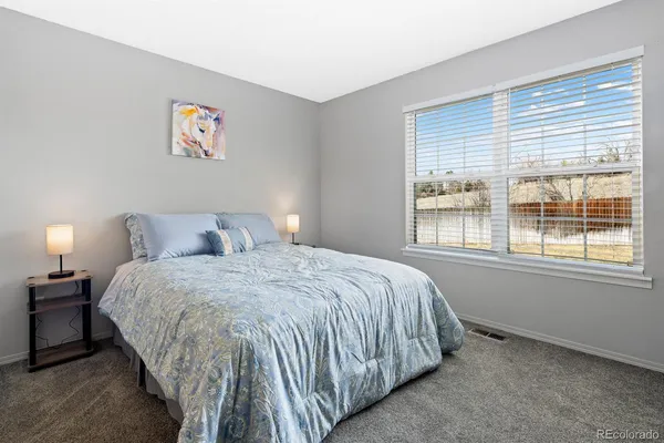 a spacious bedroom with a bed and a window