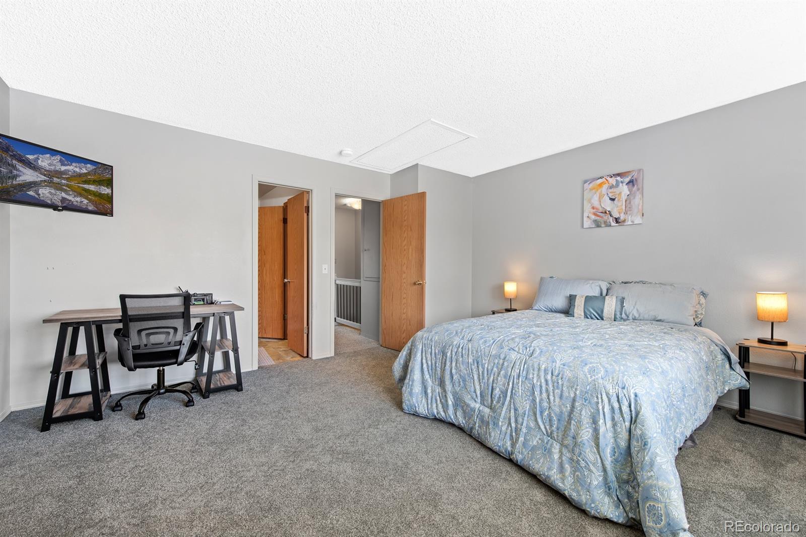 19927 Briarwood Court Parker, CO 80138 - Photo 25 of 29 a bedroom with a bed and a table