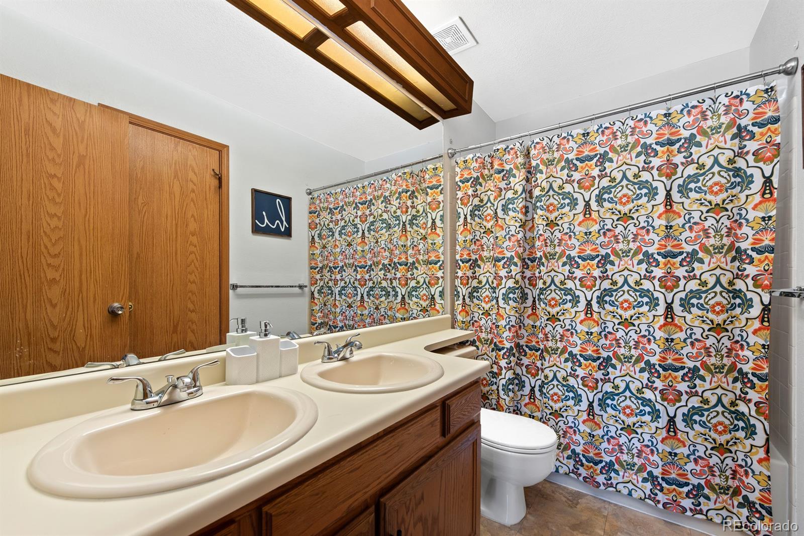 19927 Briarwood Court Parker, CO 80138 - Photo 27 of 29 a bathroom with a sink and a mirror