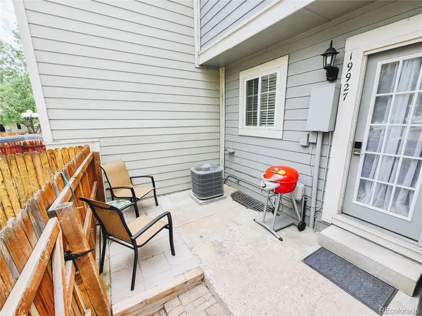a view of a house with backyard and sitting area