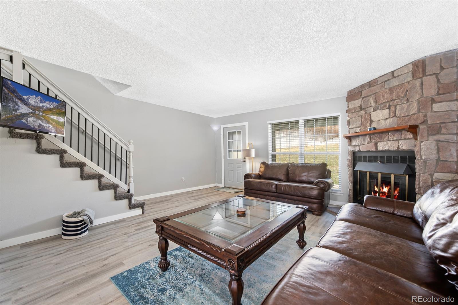 19927 Briarwood Court Parker, CO 80138 - Photo 8 of 29 a living room with furniture and a fireplace