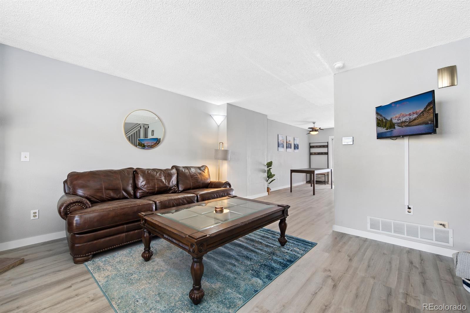 19927 Briarwood Court Parker, CO 80138 - Photo 10 of 29 a living room with furniture and a flat screen tv