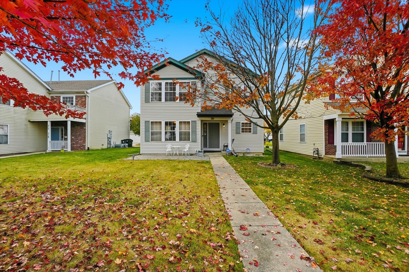 a front view of a house with a garden