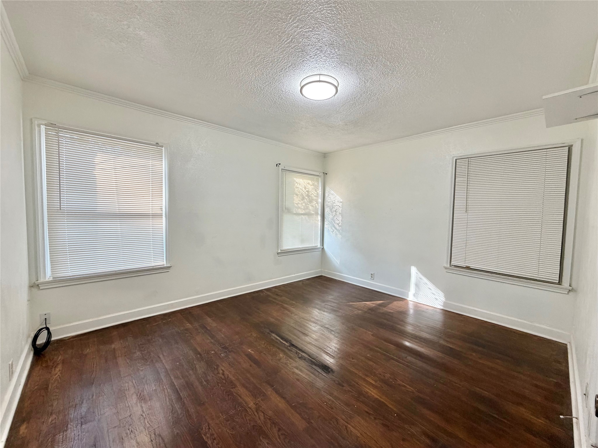 2475 Evalon Avenue Beaumont, TX 77702 - Photo 12 of 23 an empty room with wooden floor and windows