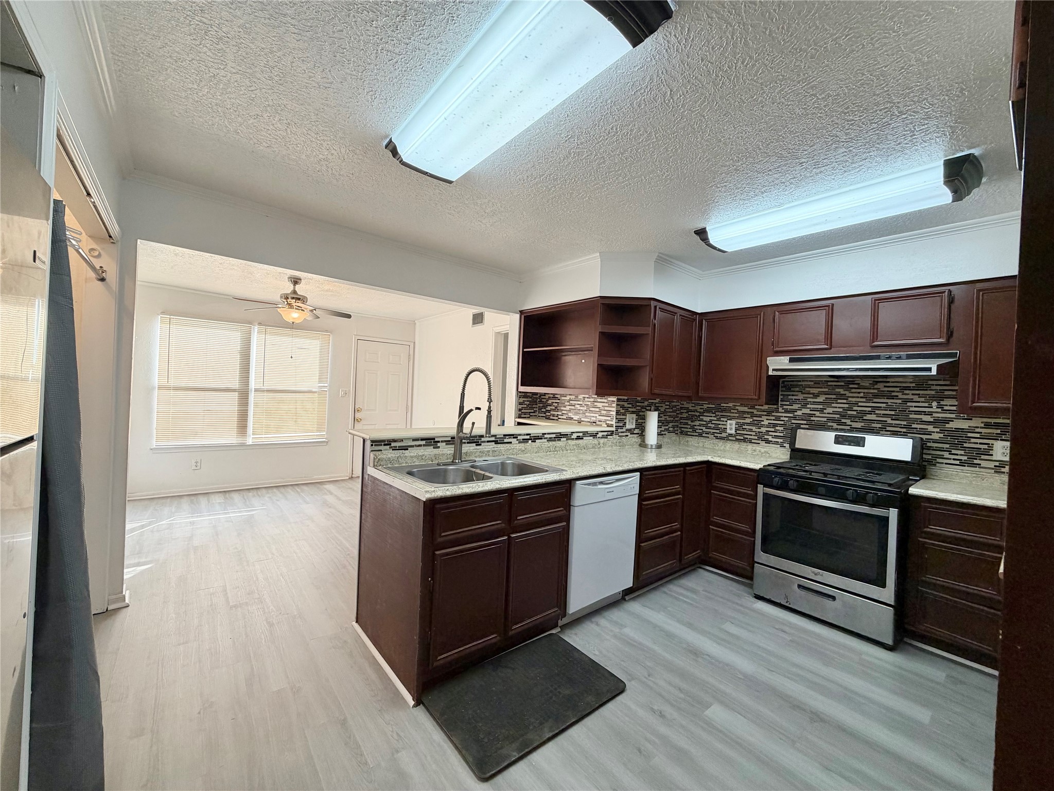 2475 Evalon Avenue Beaumont, TX 77702 - Photo 4 of 23 a kitchen with stainless steel appliances granite countertop a stove and a sink