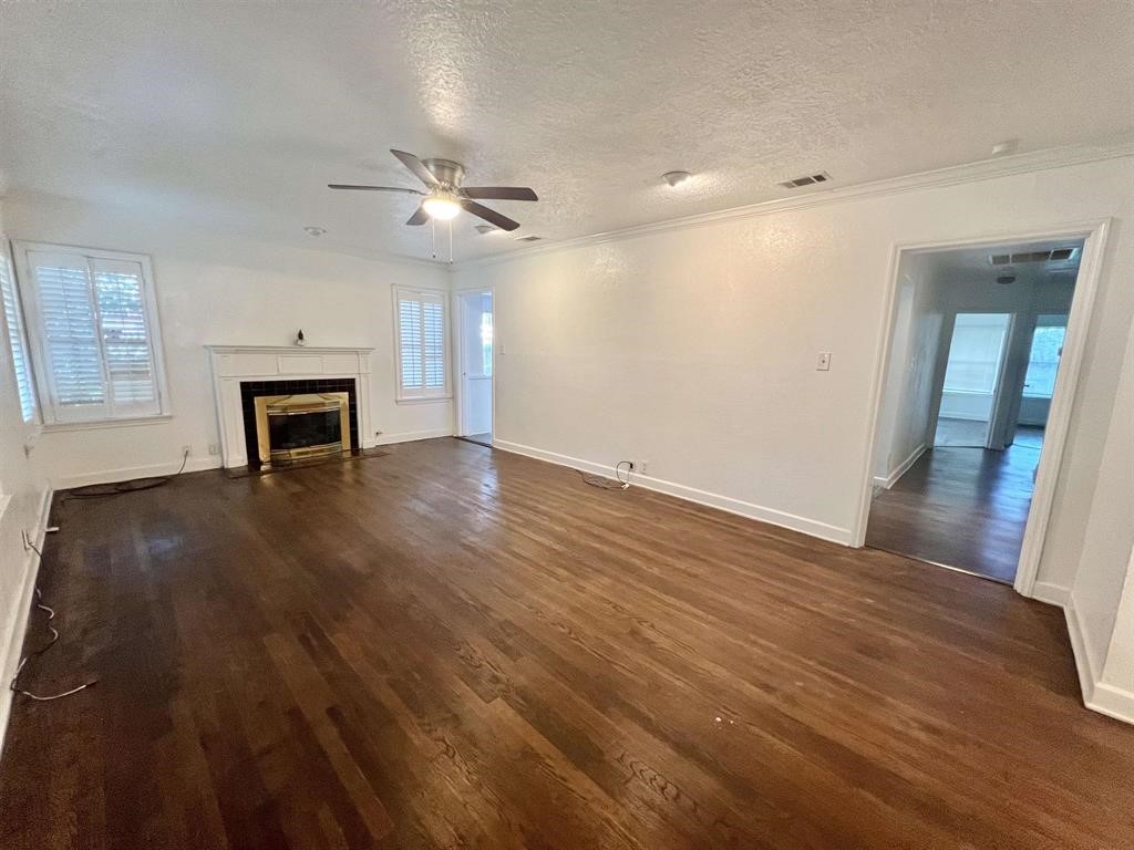 2475 Evalon Avenue Beaumont, TX 77702 - Photo 8 of 23 wooden floor in an empty room with a window