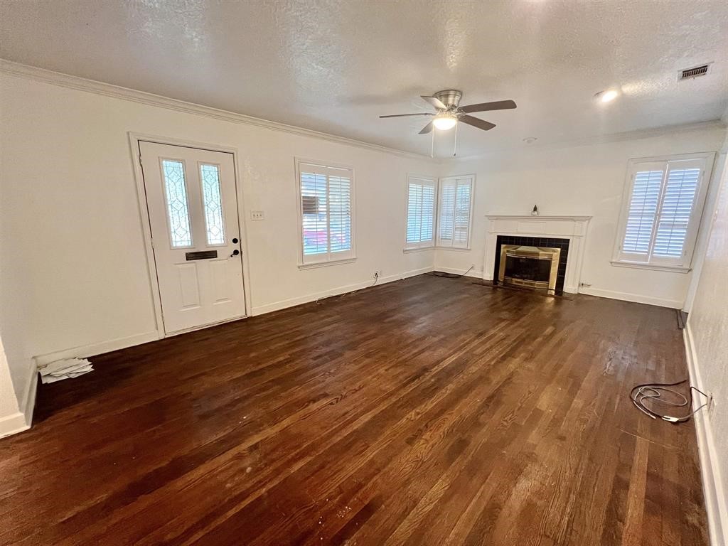 2475 Evalon Avenue Beaumont, TX 77702 - Photo 9 of 23 an empty room with wooden floor and windows