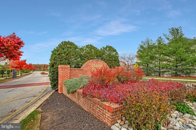 a front view of a house with a yard and a garden