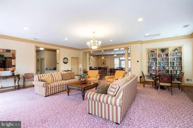 a living room with furniture a dining table and a fireplace