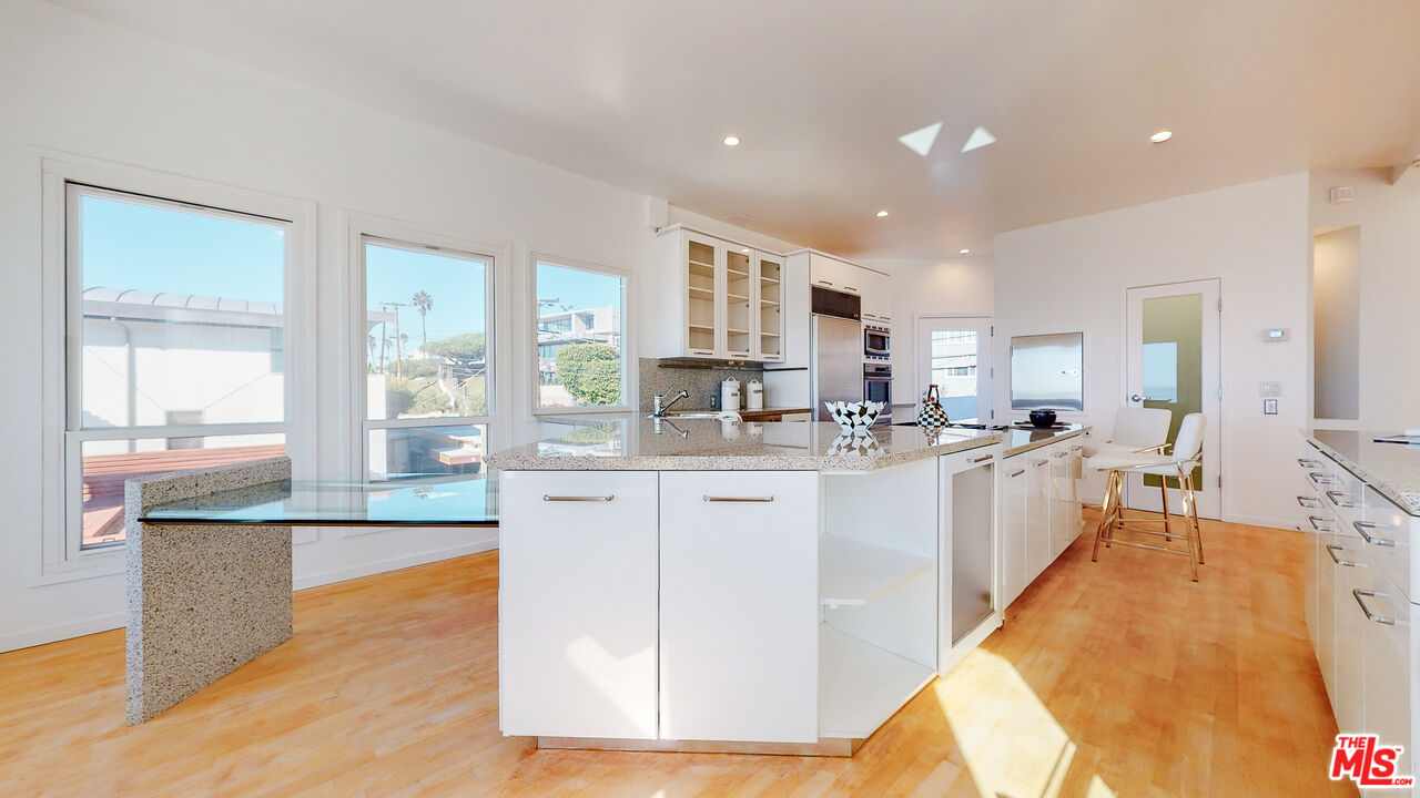 201 Waterview Street Playa del Rey, CA 90293 - Photo 22 of 54 a large kitchen with stainless steel appliances granite countertop a stove and a sink