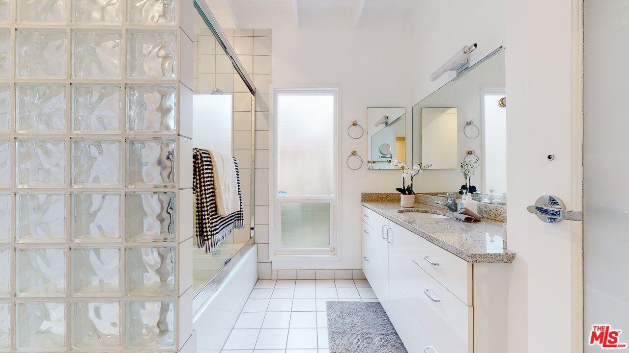 201 Waterview Street Playa del Rey, CA 90293 - Photo 40 of 54 a bathroom with a granite countertop sink a mirror and a shower