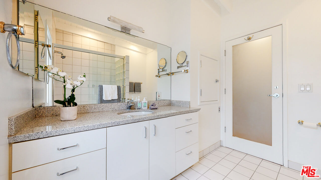 201 Waterview Street Playa del Rey, CA 90293 - Photo 45 of 54 a bathroom with a granite countertop sink mirror and vanity