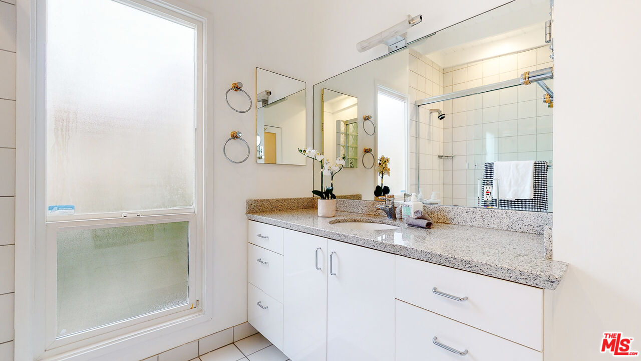 201 Waterview Street Playa del Rey, CA 90293 - Photo 46 of 54 a bathroom with a granite countertop sink and a mirror