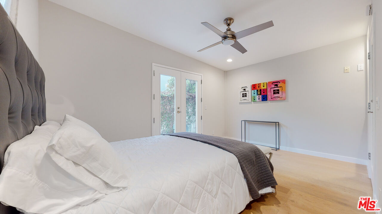 201 Waterview Street Playa del Rey, CA 90293 - Photo 49 of 54 a bedroom with a large bed and a ceiling fan