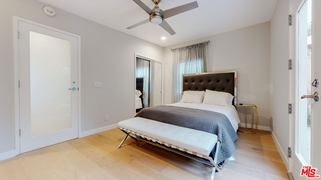 201 Waterview Street Playa del Rey, CA 90293 - Photo 50 of 54 a bedroom with a bed and a chandelier