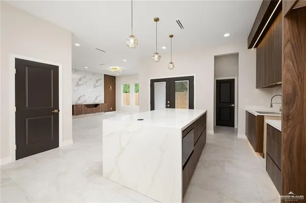 a large kitchen with cabinets and stainless steel appliances