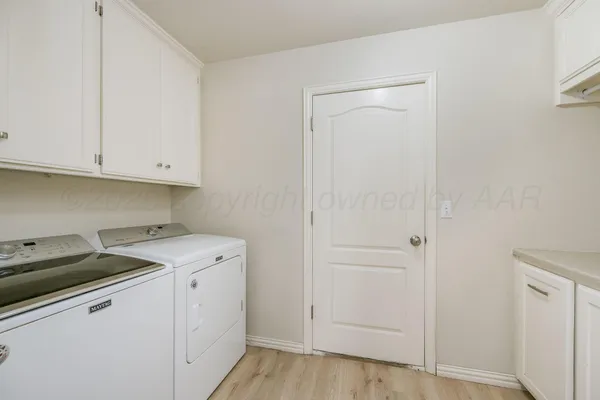 a view of cabinets with wooden floor