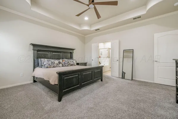 a bedroom with a bed and ceiling fan