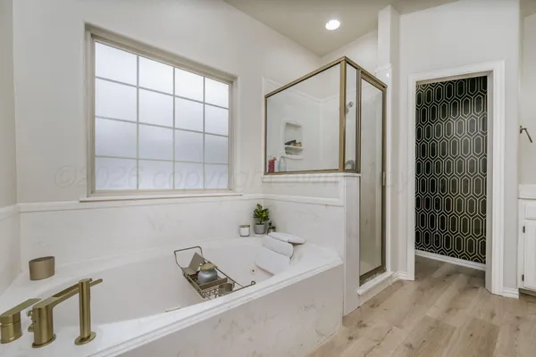 a bathroom with a bathtub and a shower