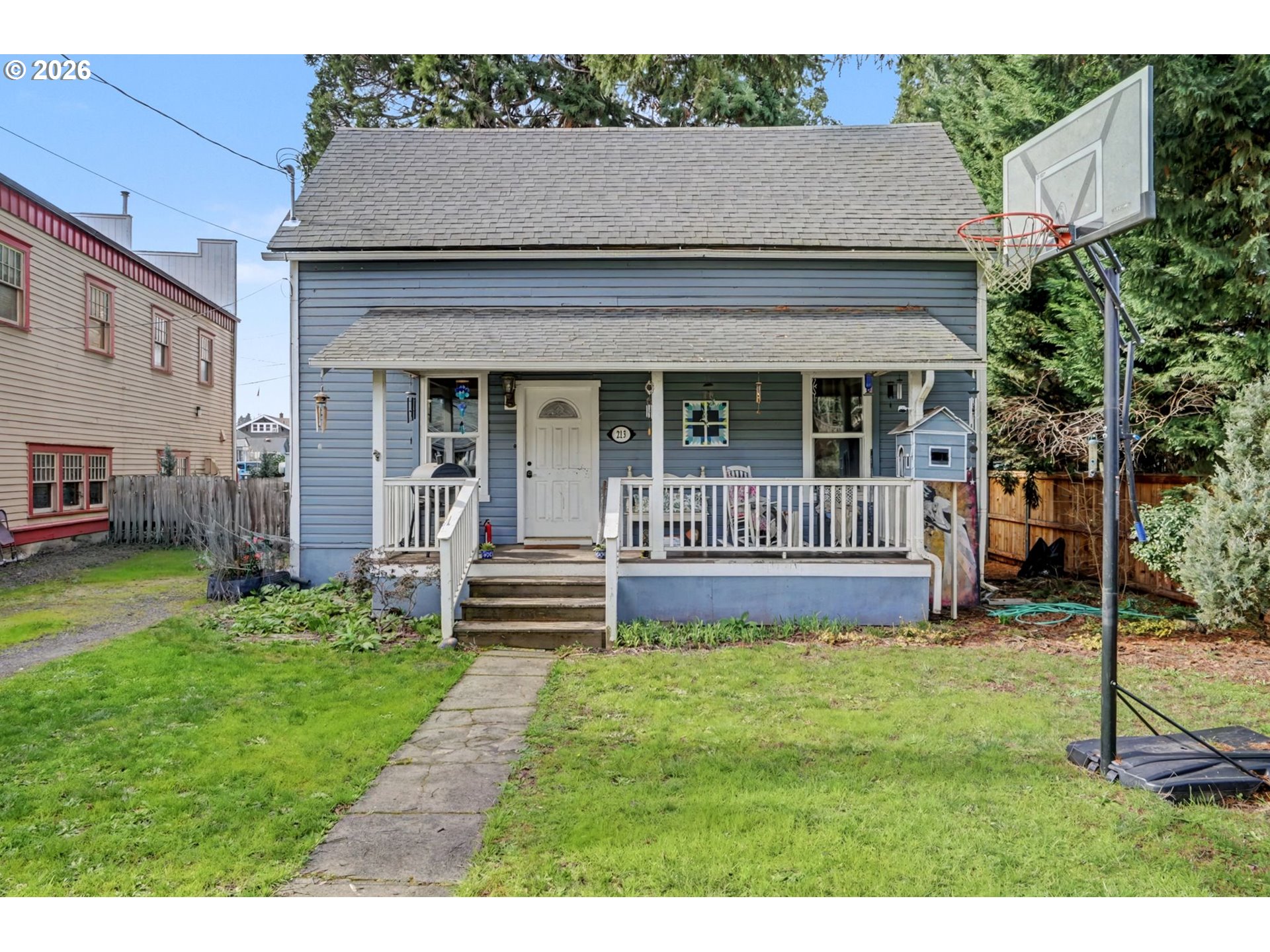 213 Mill Street Silverton, OR 97381 - Photo 1 of 25 a view of a house with a yard and a large tree